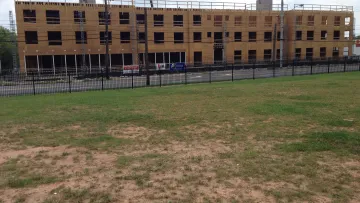 a large building with a fence in front of it