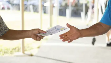 a few hands holding a card