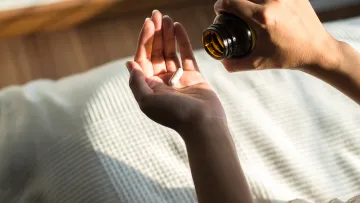 a person's hand holding medicine