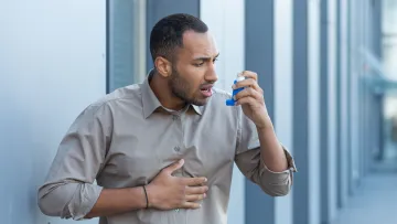 a man holding an inhaler