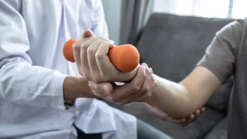 a person holding an orange weight