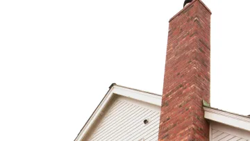 a white connecticut house with a red chimney