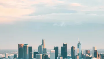 a city skyline with a cloudy sky