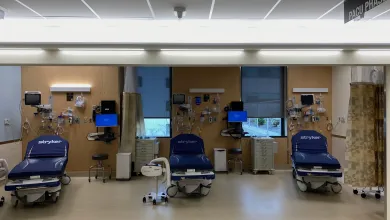 a room with blue chairs and a large screen