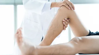 doctor examining knee