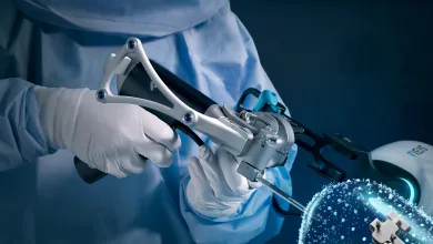 Surgeon holding a high-tech robotic surgical instrument with glowing digital molecular structure overlay.
