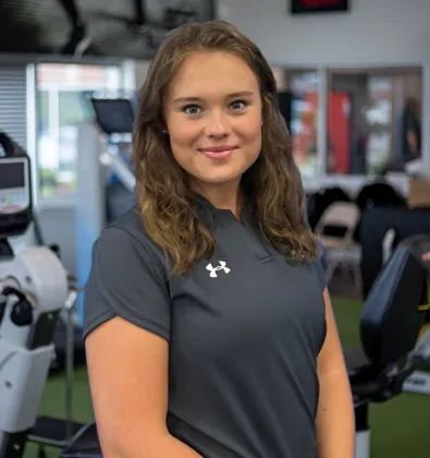 a woman standing in physical therapy office