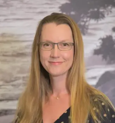 a woman with long hair and glasses