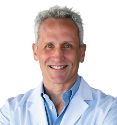 Smiling middle-aged male doctor with gray hair wearing a white coat and light blue shirt against a clear background