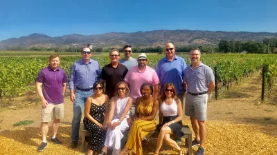 a group of people standing in a field posing for the camera