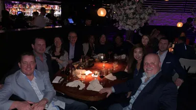 a group of people sitting at a table in a restaurant