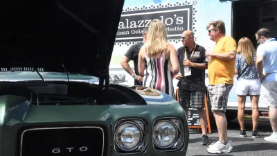 a person standing in front of a car