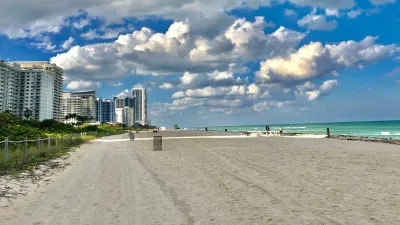 a beach with buildings in the background