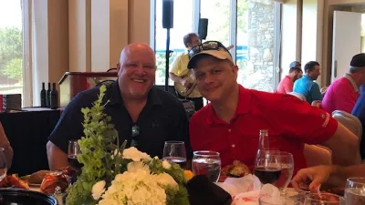 Whit Dickey et al. sitting at a table with food