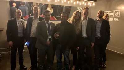 a group of people standing in front of a crowd posing for the camera