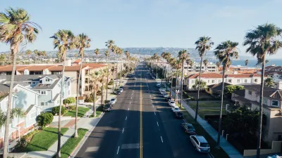 a street with palm trees and buildings
