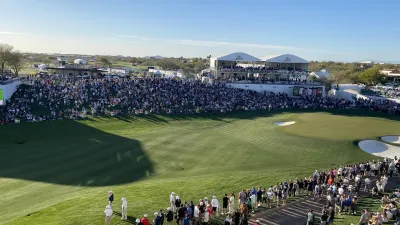 a crowd of people at a golf course