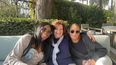 a group of women sitting on a couch outside