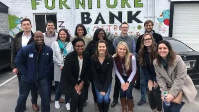 a group of people posing for a photo in front of a building