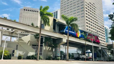 a building with palm trees and a bus parked in front