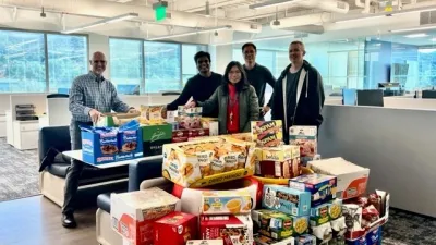 a group of people standing next to a table full of boxes