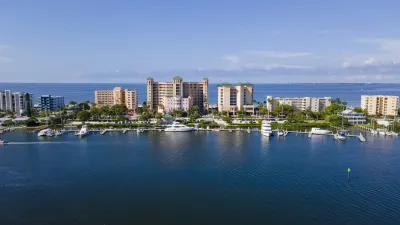 a body of water with boats in it and buildings in the back