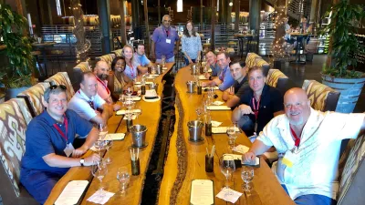 a group of people sitting at a table in a restaurant