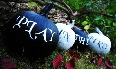 row of pumpkins painted with words
