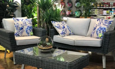 a living room filled with furniture and vase of flowers on a table