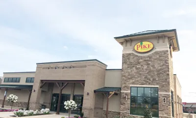 a small clock tower in front of a building