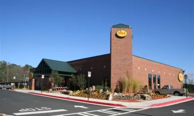 a building with a clock on the side of a road