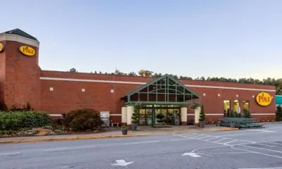 a building with a clock on the side of a road