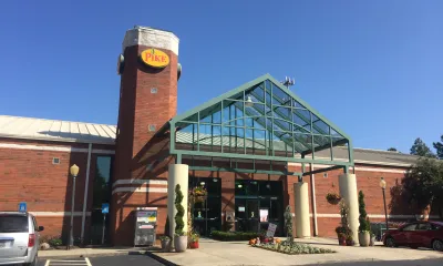 a building with a clock on the side of a road