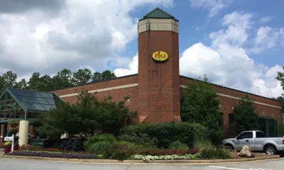 a small clock tower in the middle of a road