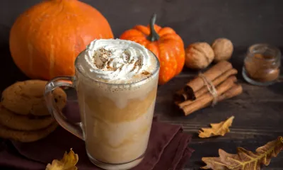 a cup of coffee and a pumpkin on a table