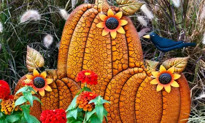 a decorative metal garden stake showing 3 pumpkins