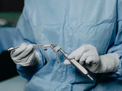 a person in surgical scrubs holding a syringe