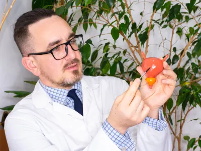 a man holding a tomato