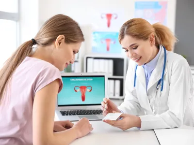 a doctor showing a patient something on the laptop