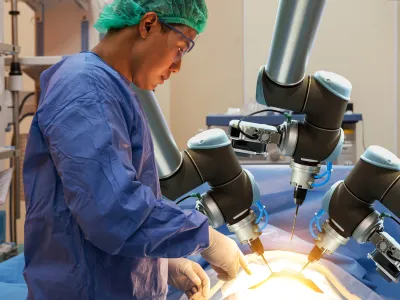 a man in a blue coat working on a machine