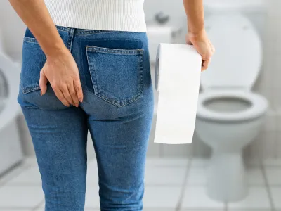 a person standing in front of a toilet