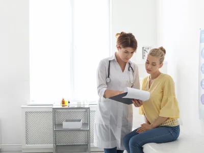 a doctor showing a patient something on the tablet