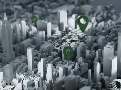 3D cityscape with tall buildings and green location pins marking key urban points in a grayscale model.