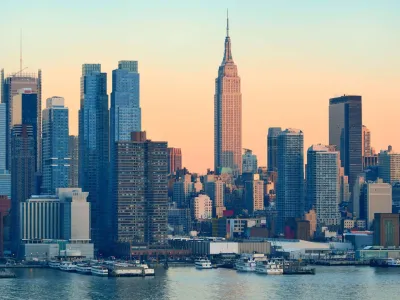 New York City skyline at sunset with Empire State Building and Hudson River in view