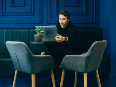 Tamás Lengyel sitting at a table with a laptop