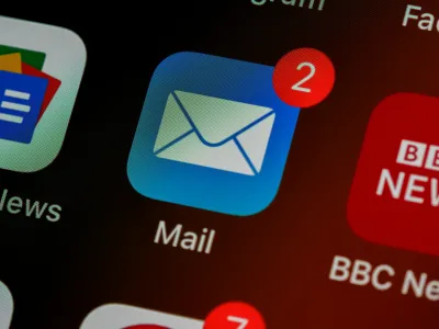 Blue mail app icon with two unread messages shown by red notification badge on smartphone screen.