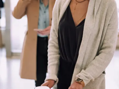 a few women looking at a cell phone