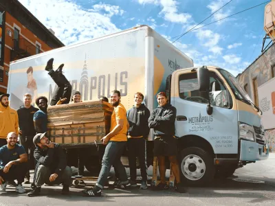 a group of people posing for a photo next to a truck