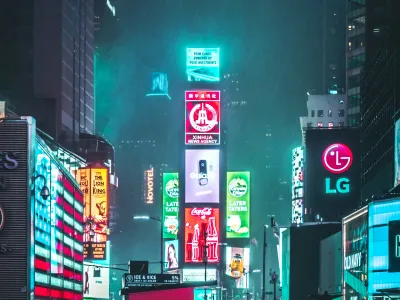 Vibrant view of Times Square at night, featuring colorful neon lights and bustling crowds.