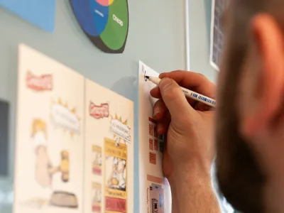 a person writing on a white board